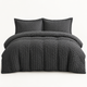 Seersucker Textured Duvet Cover Set in dark grey layered on a made bed