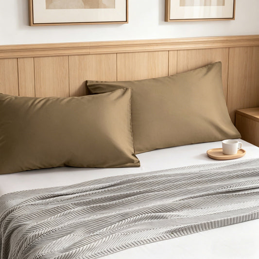 Cotton envelope pillowcase set on a made bed