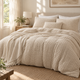 A made bed in a champagne beige seersucker duvet cover set from Calm Cloud Bedding