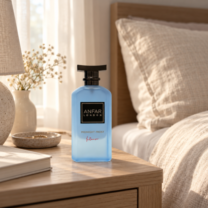 Anfar London Midnight Frost Intense perfume bottle on a pale wooden bedside table beside linen bedding in morning light
